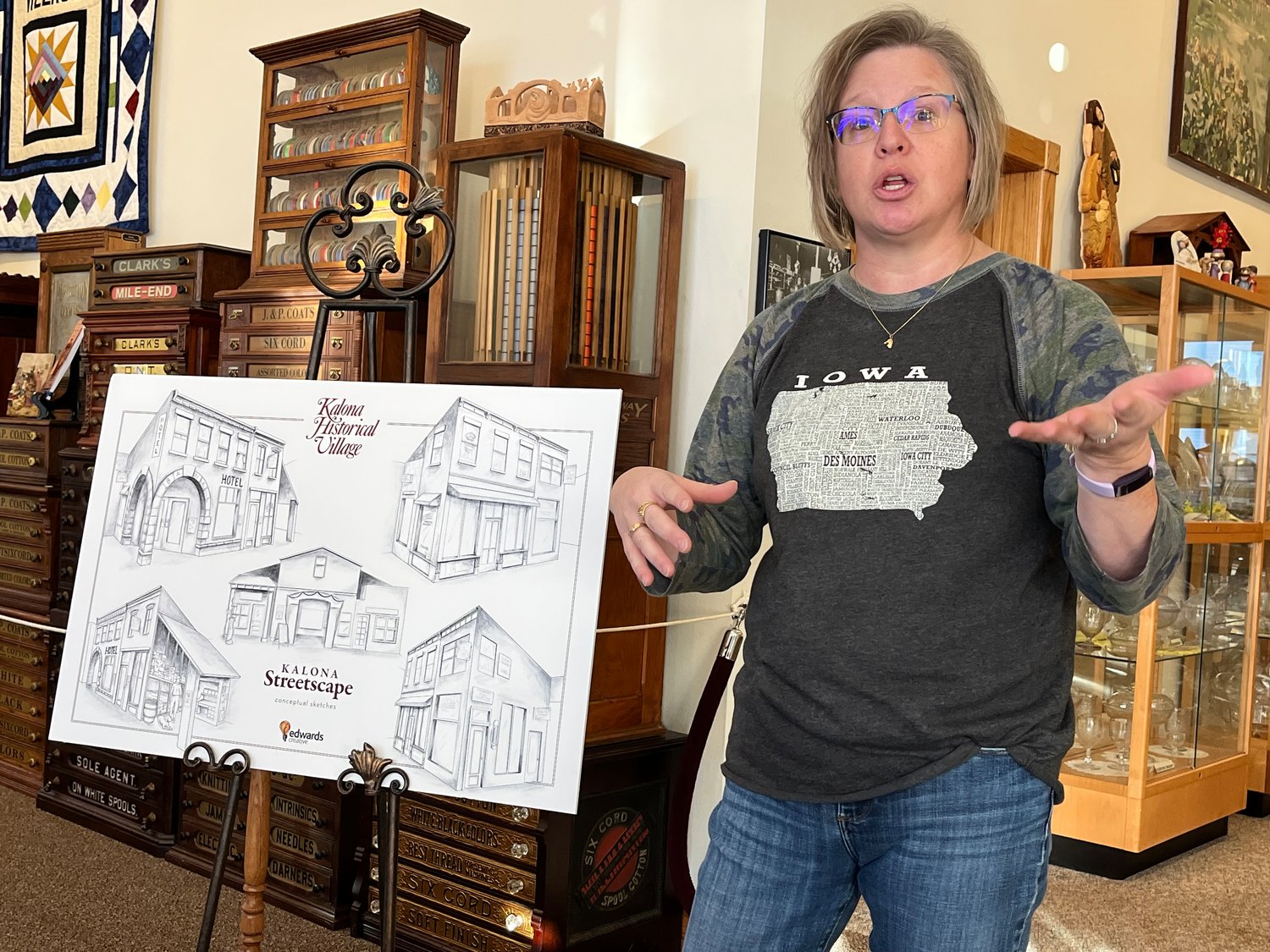 Nancy Roth shows off plans for the Kalona Streetscape at the Chamber Brunch on Monday, Jan. 10.